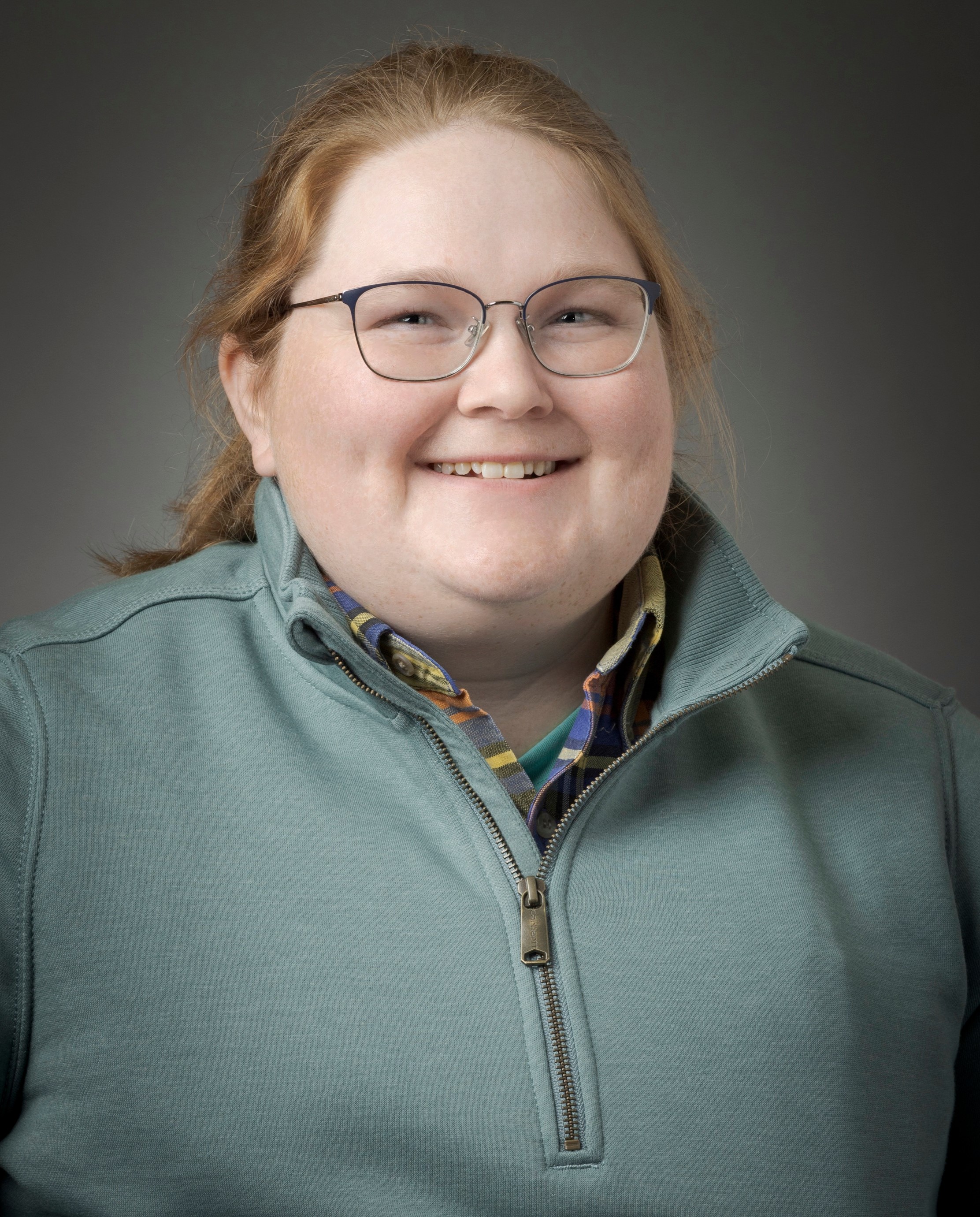 A smiling woman with glasses